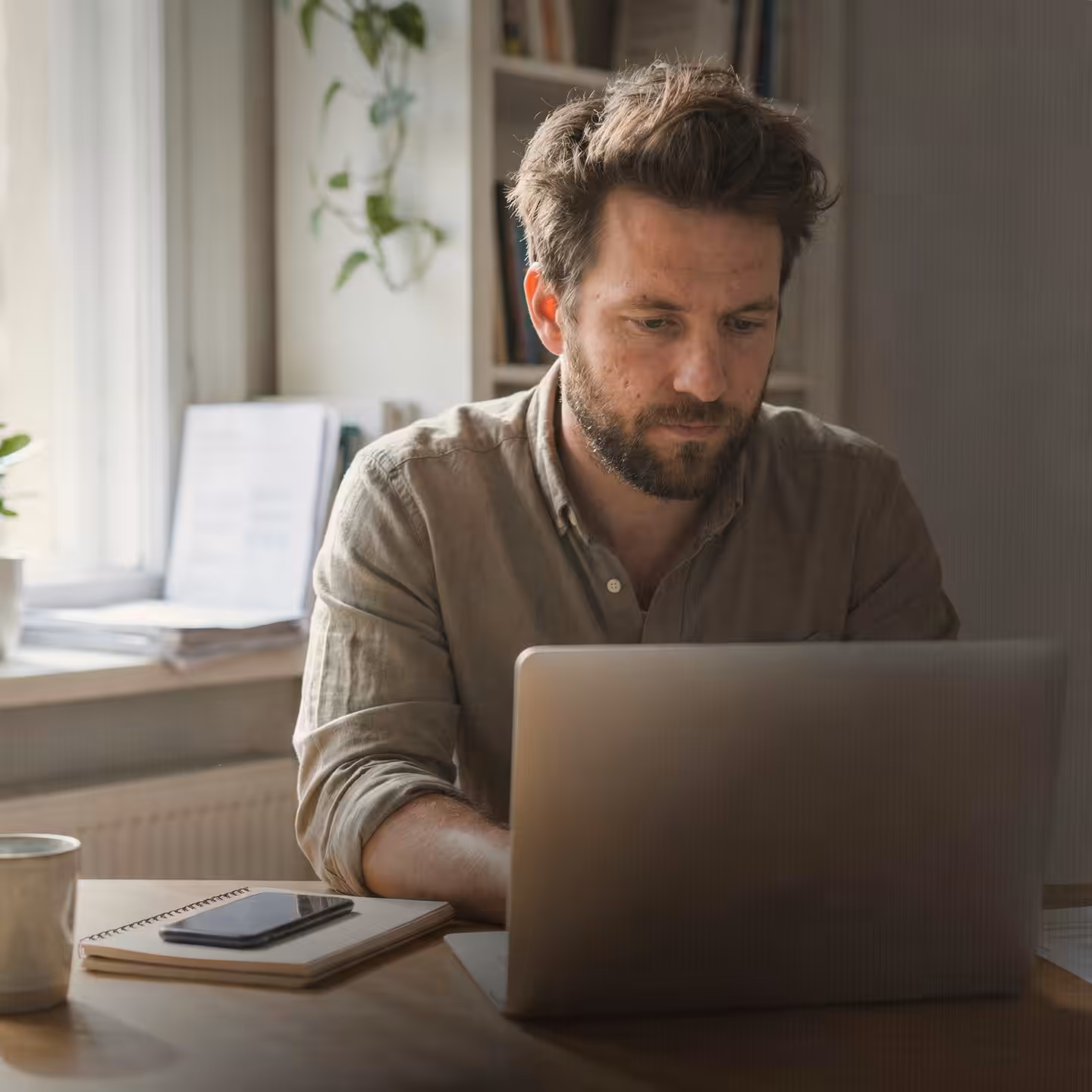 Focused entrepreneur working on laptop in modern workspace representing U.S. LLC business setup